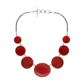 Women’s sterling silver necklace with polished coral discs and Bali-inspired accents.